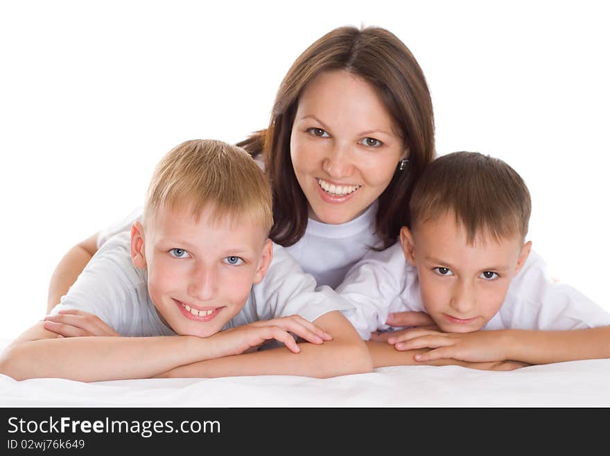 Smiling beautiful mom with  her sons sitting at the desk. Smiling beautiful mom with  her sons sitting at the desk