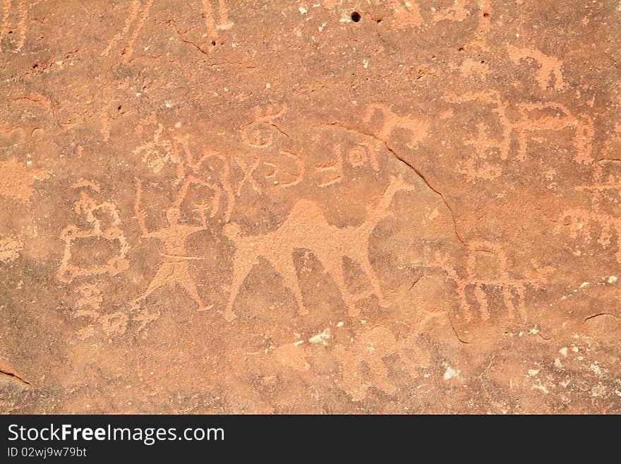 Images of people and camels carved into a rock wall at Wadi Rum, a UNESCO World Heritage site in Jordan.