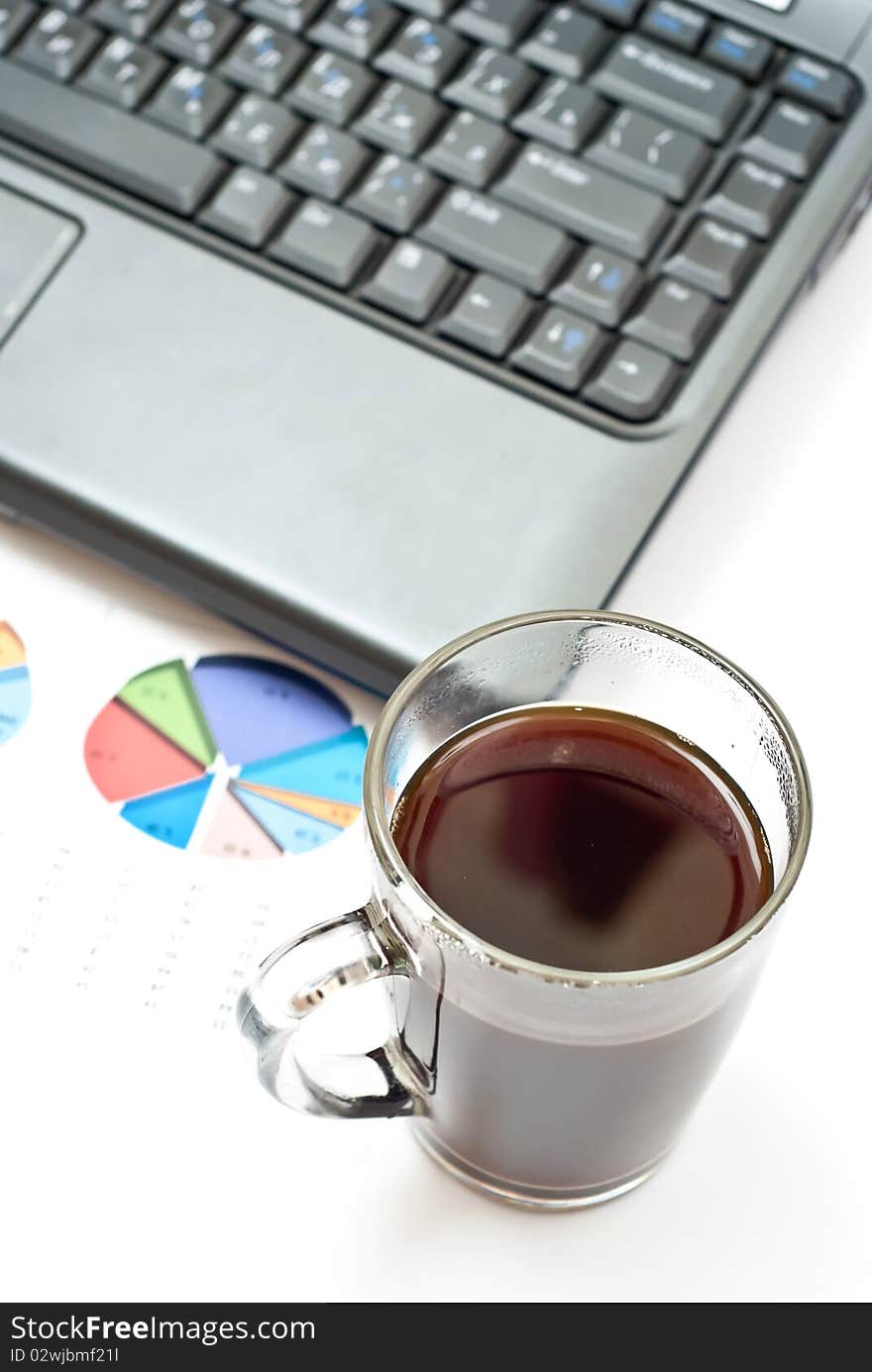 Office table with notebook, charts and cup of hot coffee. Office table with notebook, charts and cup of hot coffee