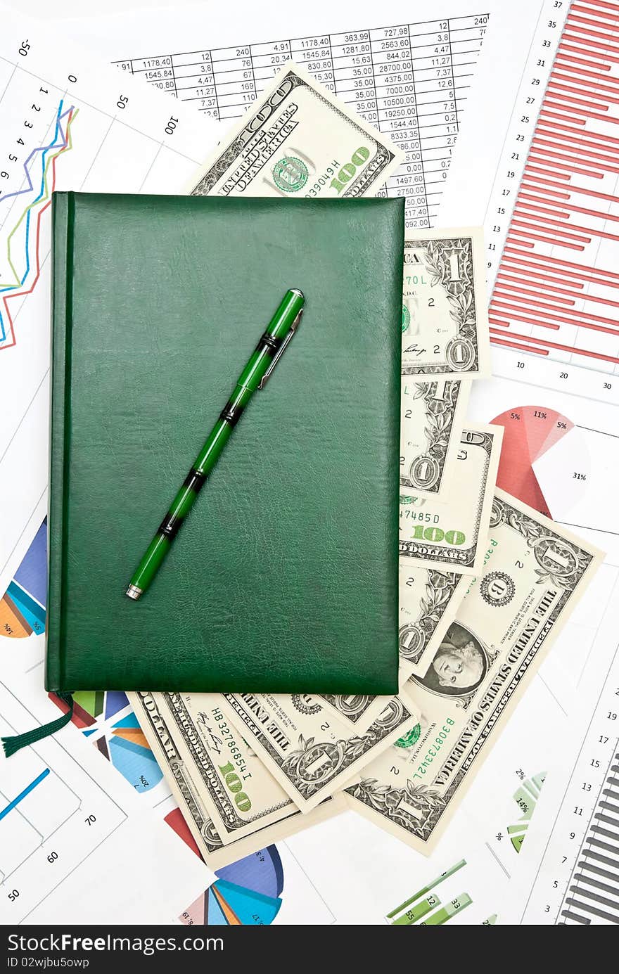 Notebook with money on business charts and diagrams. Notebook with money on business charts and diagrams