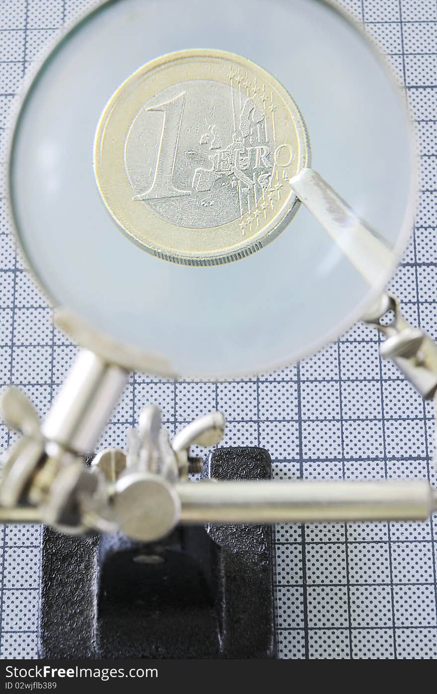 Euro coin under magnifier