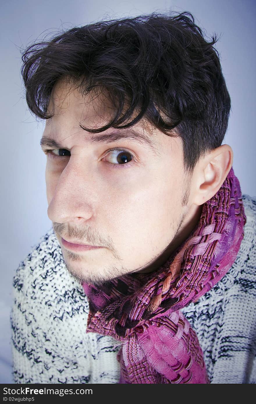 Dishevelled young man with a pink scarf. Dishevelled young man with a pink scarf