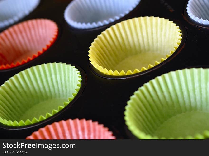 Colorful cake tins being prepared.