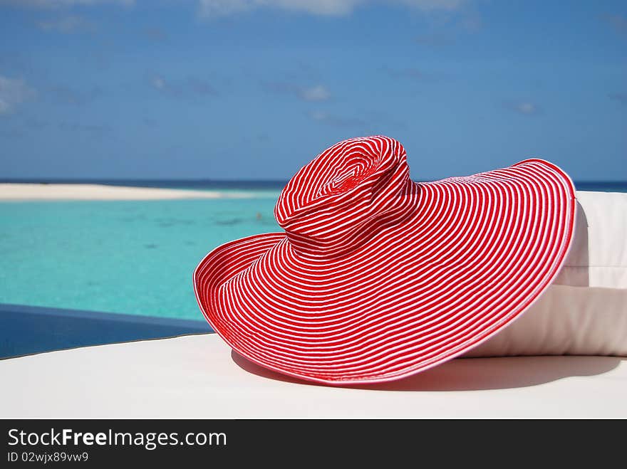 Bonnet on a sunbed on a seashore. Bonnet on a sunbed on a seashore