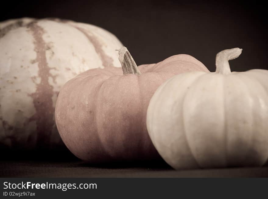 Seasonal holiday background with pumpkins in aged photo