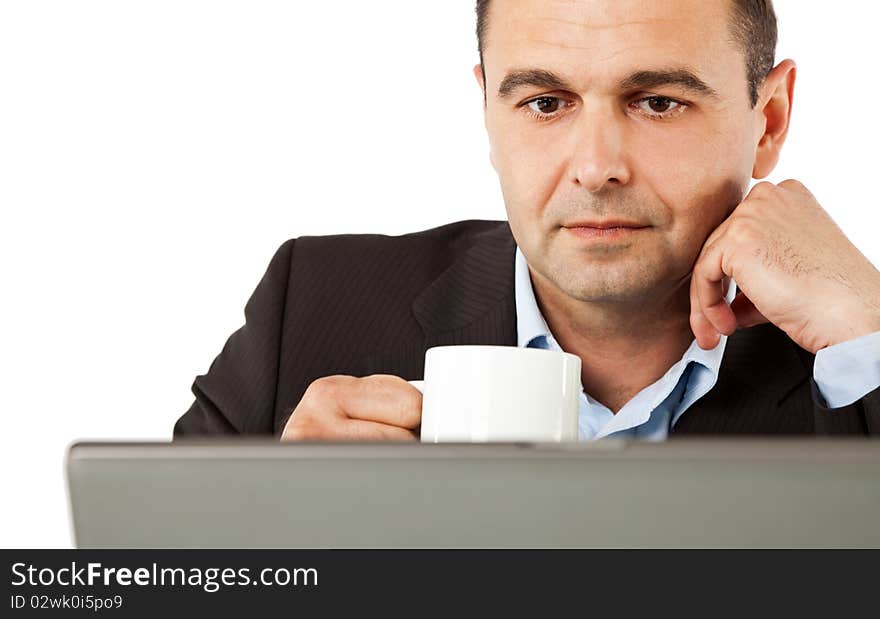 Portrait of businessman behind laptop drinking coffee, isolated. Portrait of businessman behind laptop drinking coffee, isolated