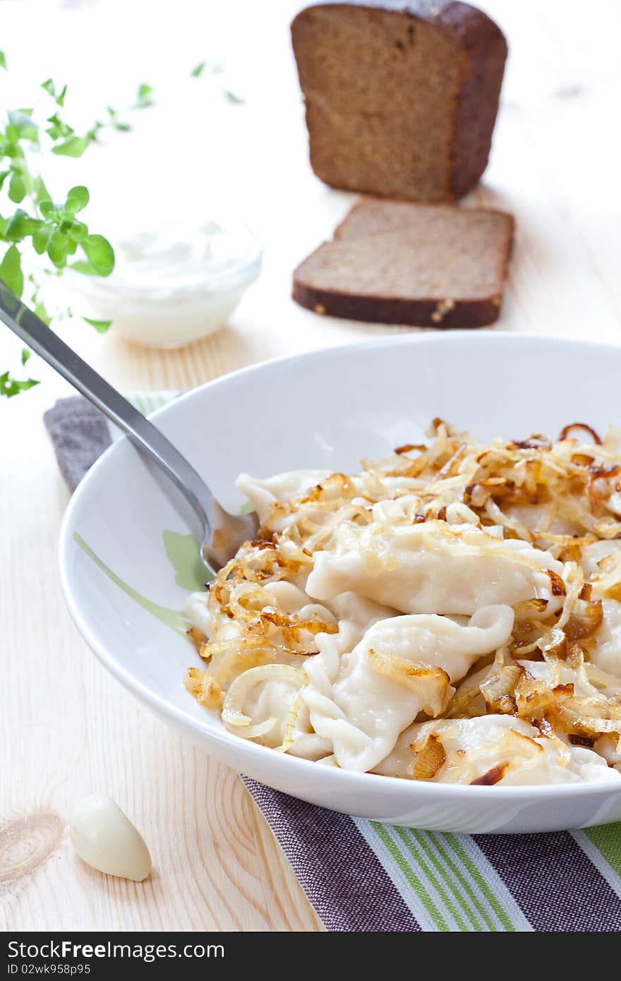 Potato dumplings served with fried onion