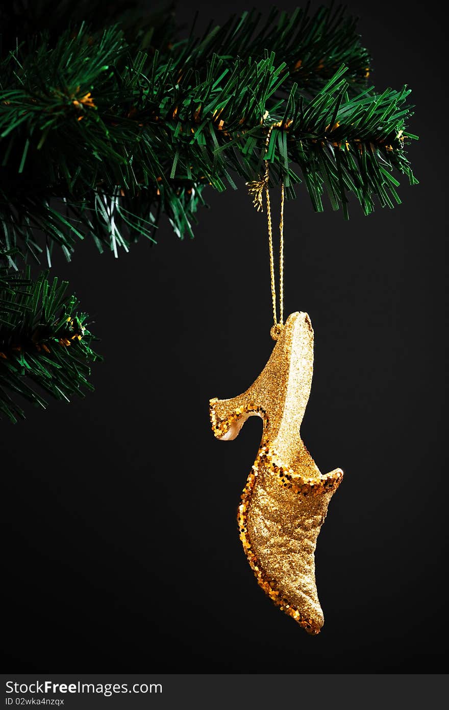 Gold shoe on the artificial Christmas tree