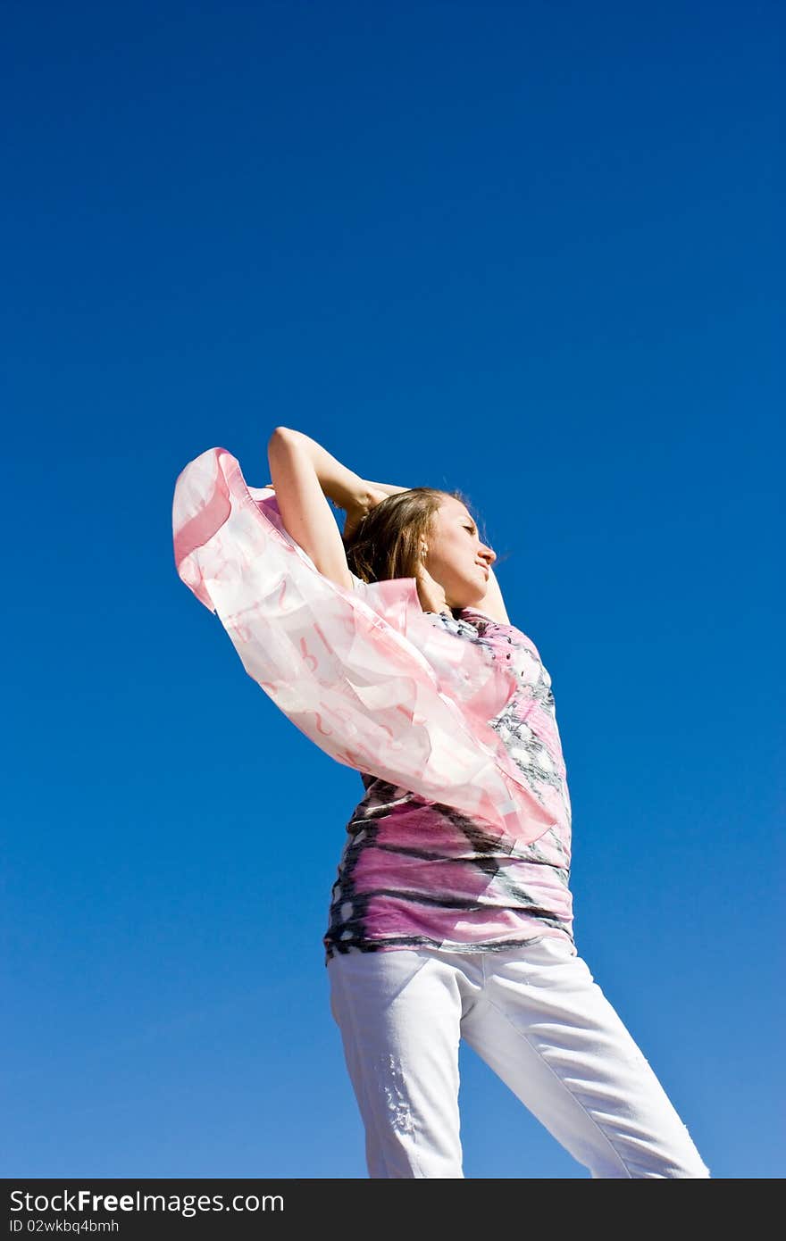 Happy young lady playing with her scarf near the sea, in the wind. Happy young lady playing with her scarf near the sea, in the wind