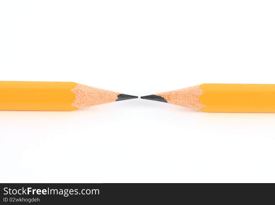 Two pencils in opposite isolated on white.