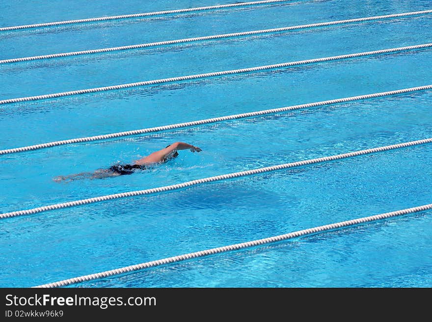 Young Male Freestyle Swimmer in Action. Young Male Freestyle Swimmer in Action