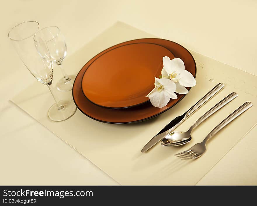 Plate on table with orchid flower