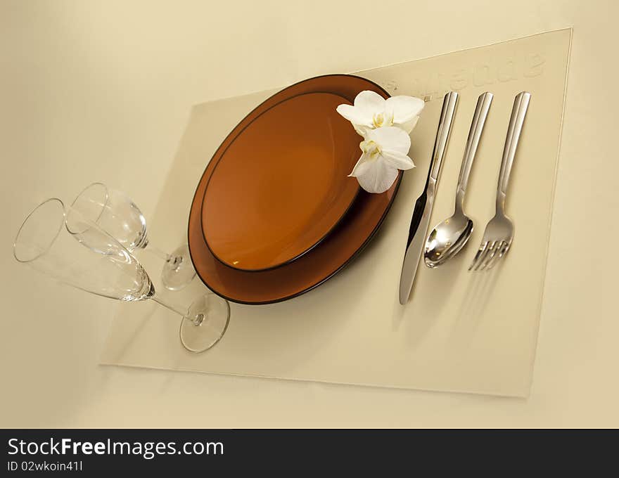 Plate on table with orchid flower