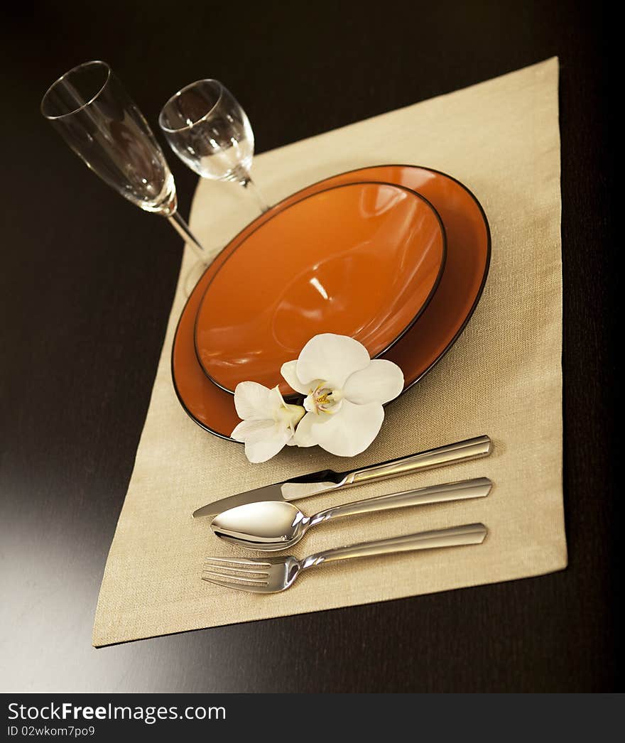 Plate on table with orchid flower