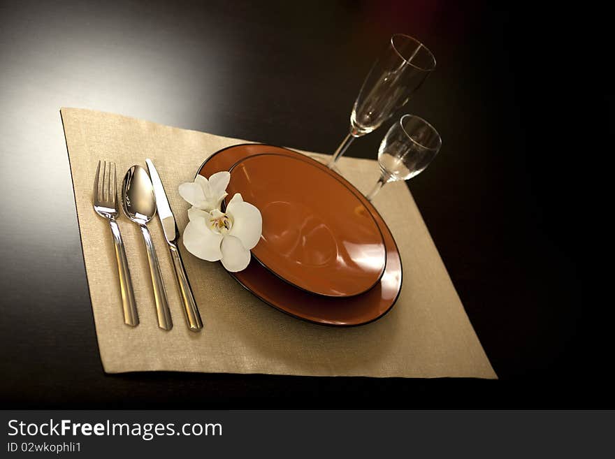 Plate on table with orchid flower