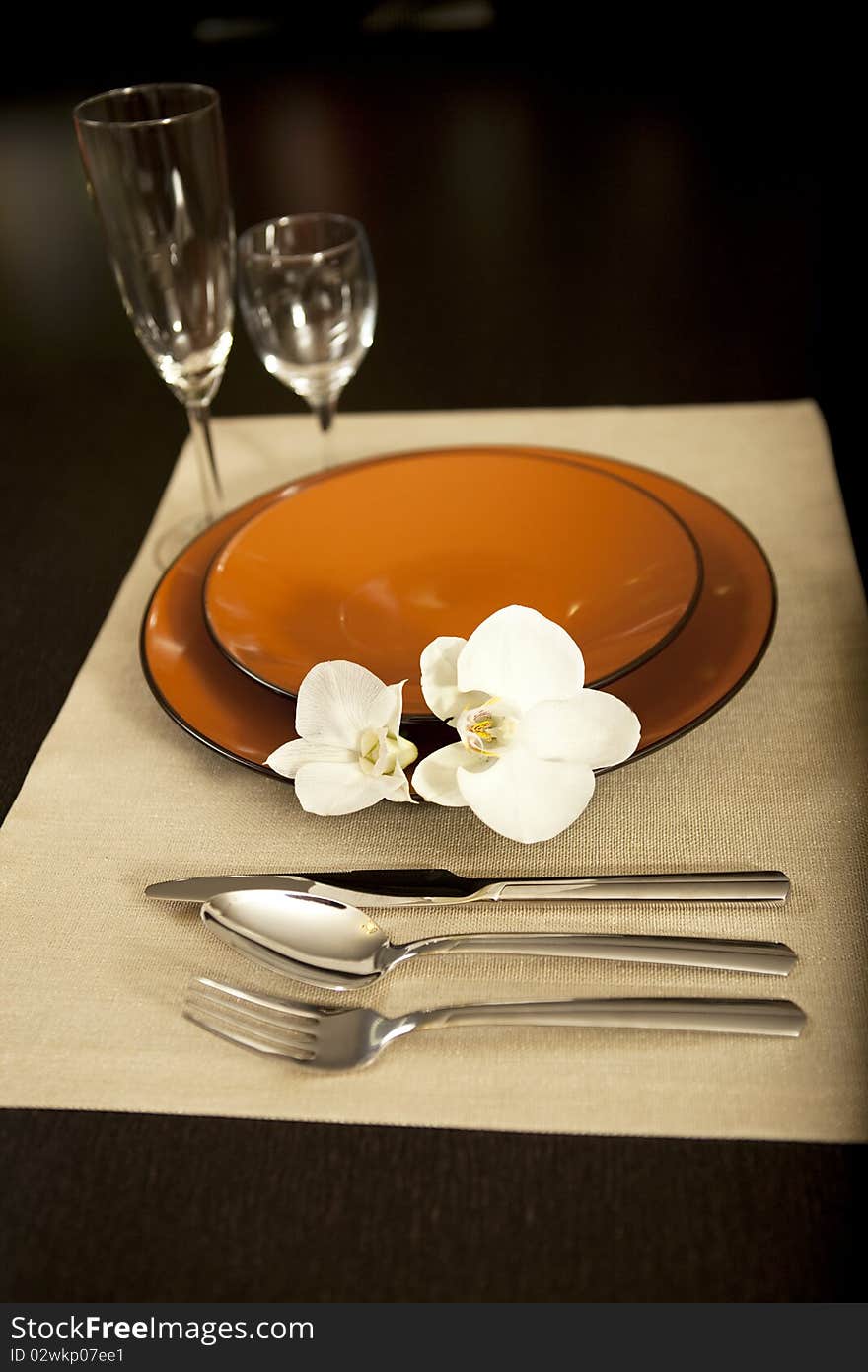 Plate on table with orchid flower