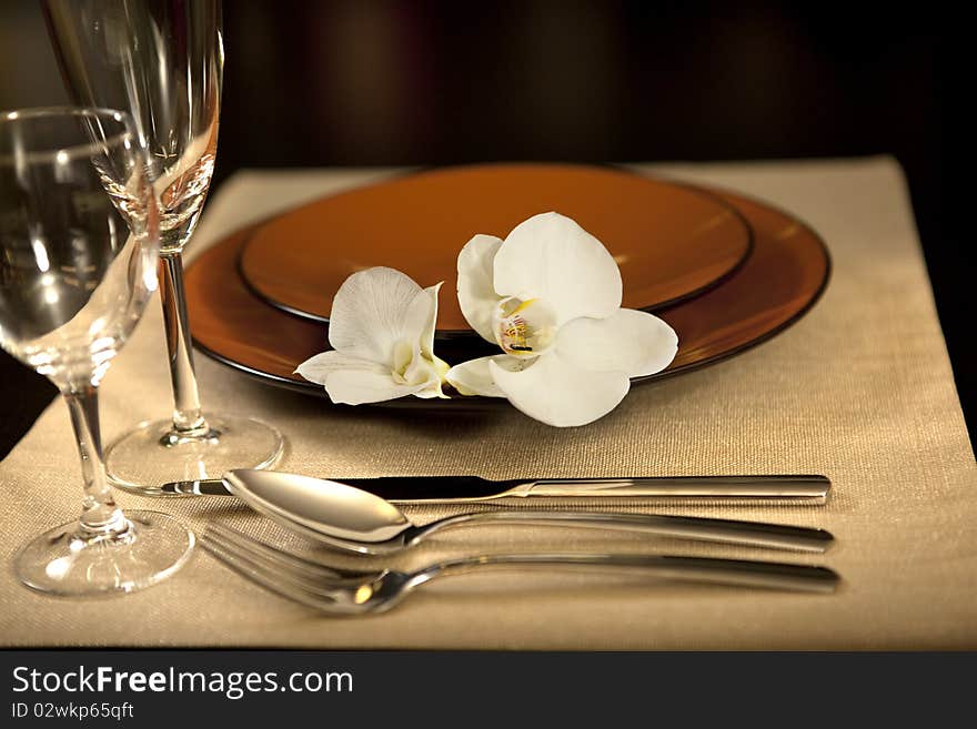 Plate on table with orchid flower