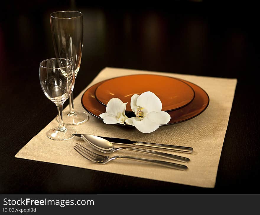 Plate on table with orchid flower