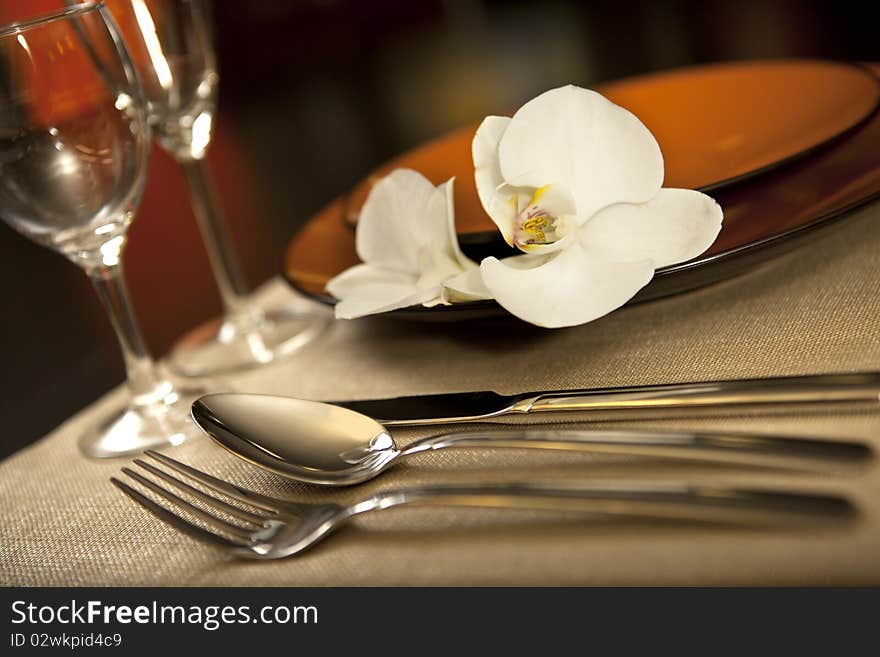 Plate on table with orchid flower