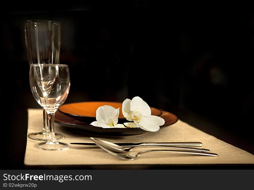 Plate on table with orchid flower