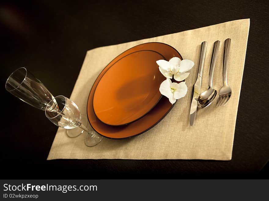 Plate on table with orchid flower