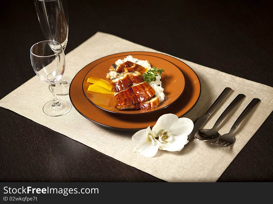 Plate on table with orchid flower