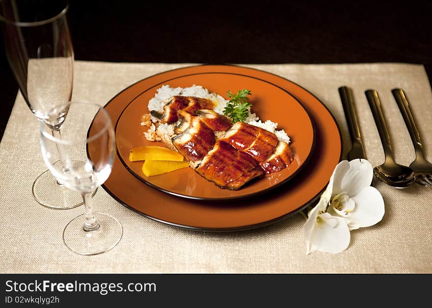 Plate on table with orchid flower