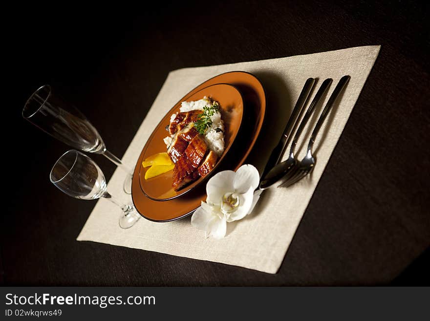 Plate on table with orchid flower