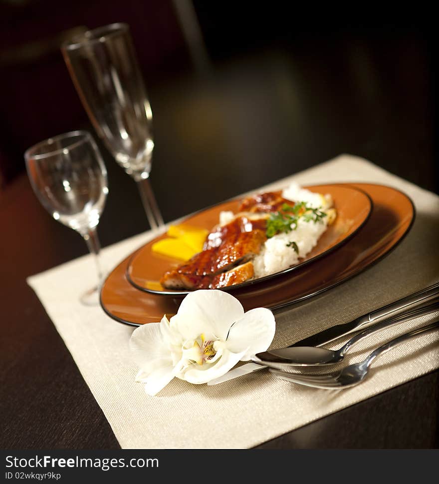 Plate on table with orchid flower