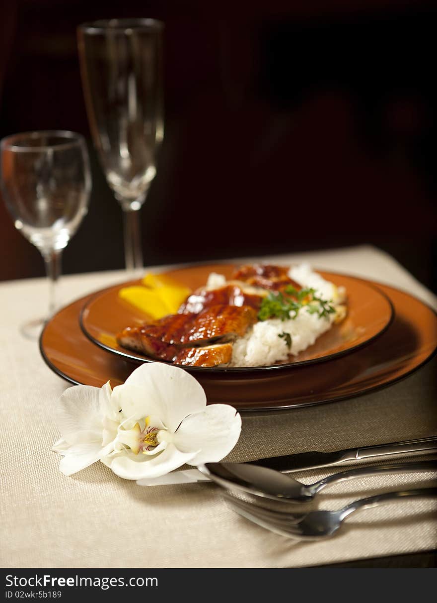 Plate on table with orchid flower