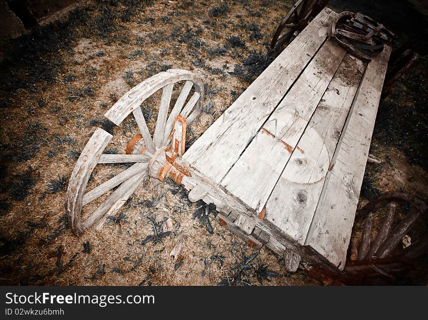 Old broken wooden wagon and wheel. Old broken wooden wagon and wheel.