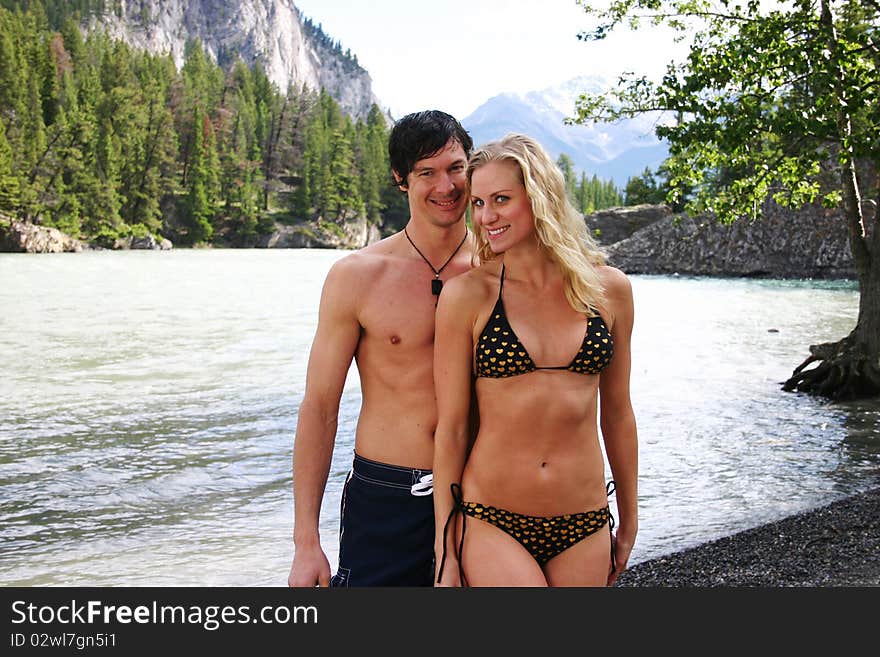 Couple in swim suits with mountains in background