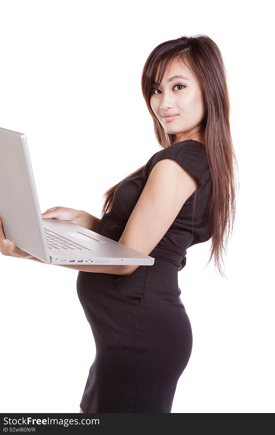 A pregnant woman is holding a laptop and dressed in a black dress. A pregnant woman is holding a laptop and dressed in a black dress.