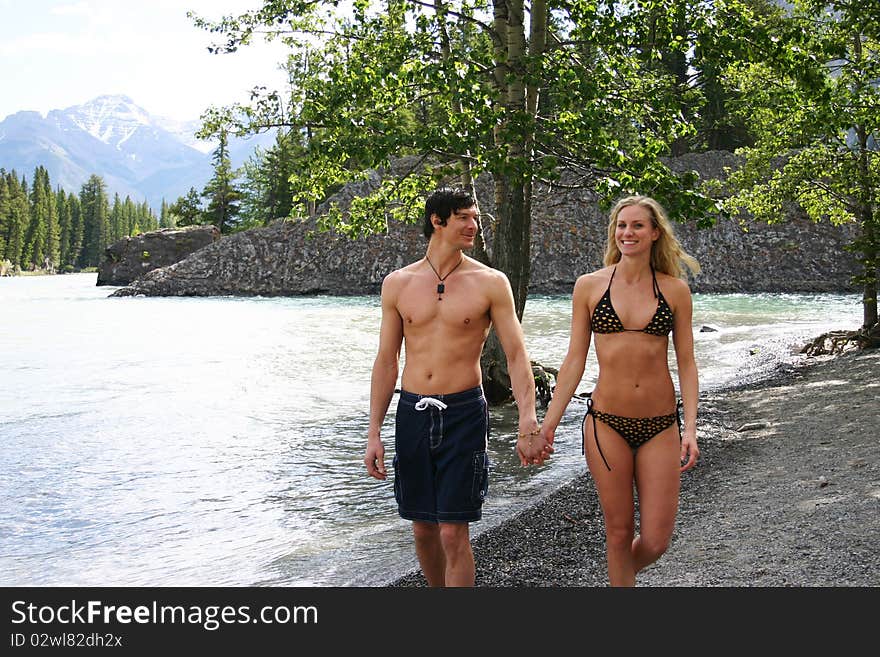 Couple walking on beach in swim suits