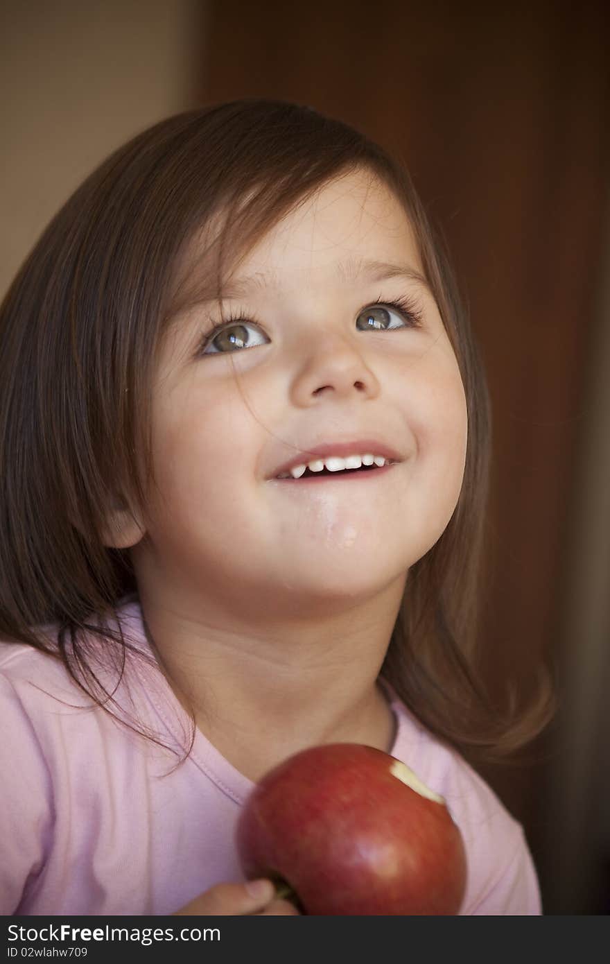 Portrait of a beautiful girl of three years With apple. Portrait of a beautiful girl of three years With apple