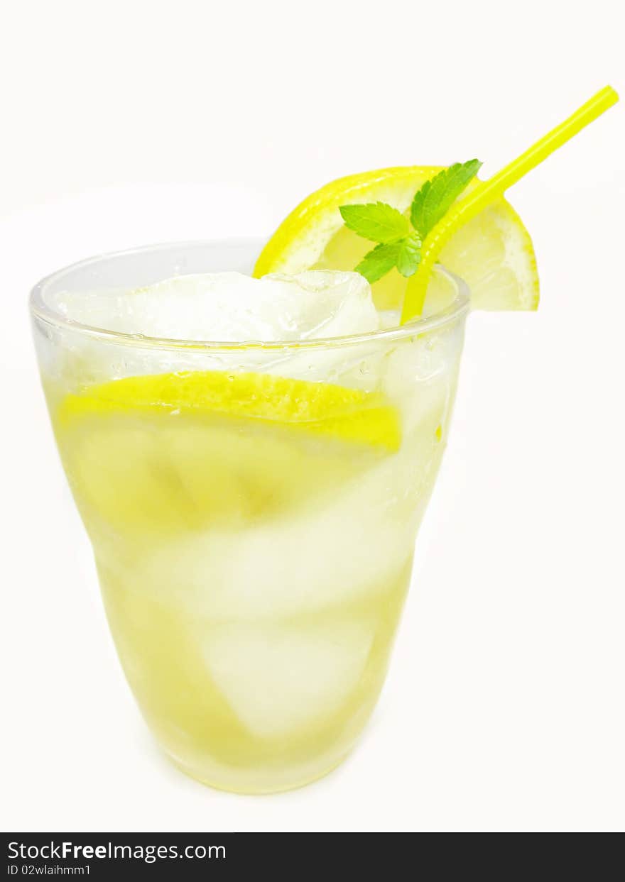 Yellow lemonade with lemon and ice