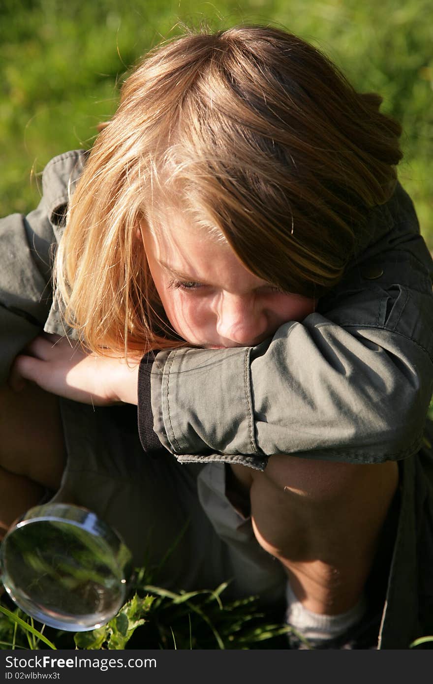 Young boy looking through magnifying glass. Young boy looking through magnifying glass