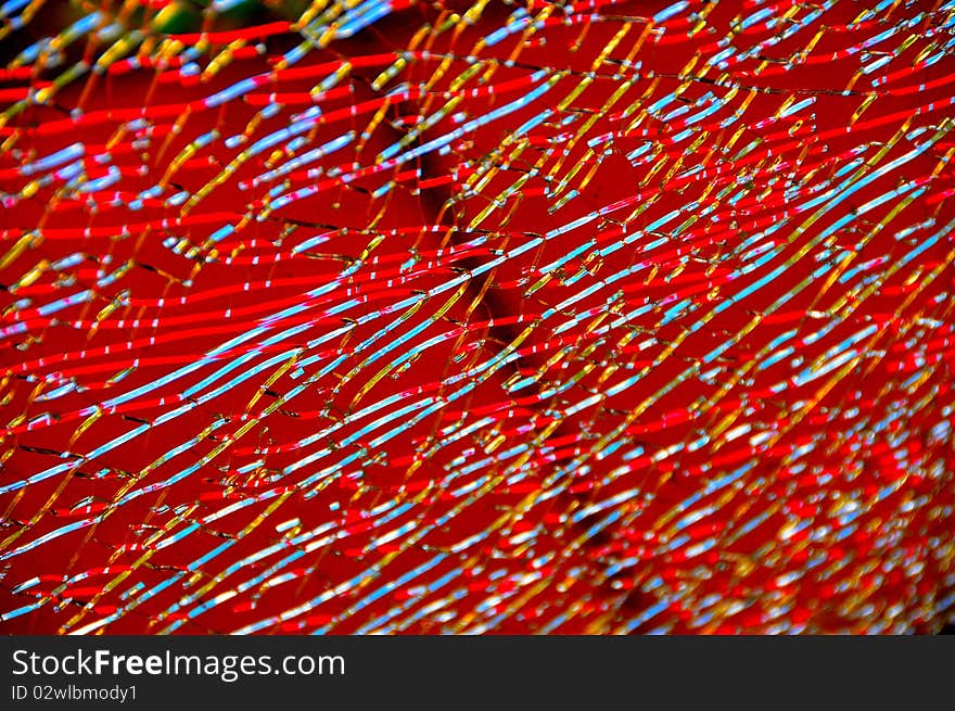 Colored Reflections of Cracks in Broken Glass with Black Background. Colored Reflections of Cracks in Broken Glass with Black Background