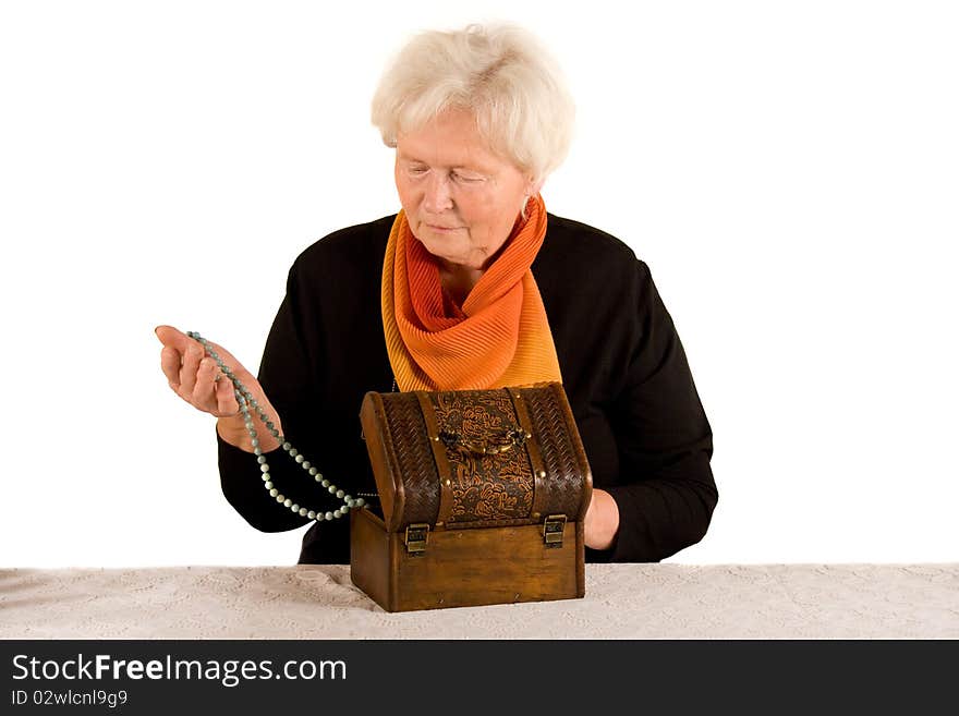 Senior woman with jewelery in her hand. Senior woman with jewelery in her hand