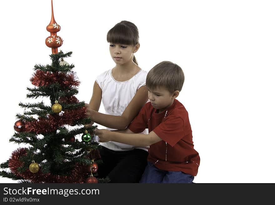 Children decorate a New Year tree, two children