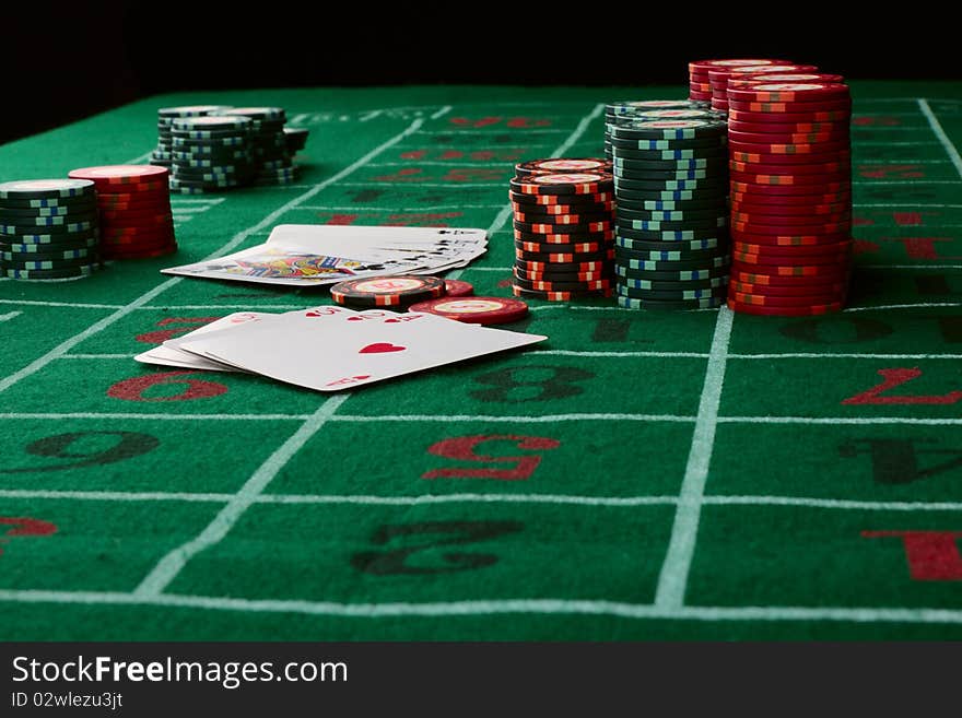 Casino card game showing chips on green cloth background. Casino card game showing chips on green cloth background