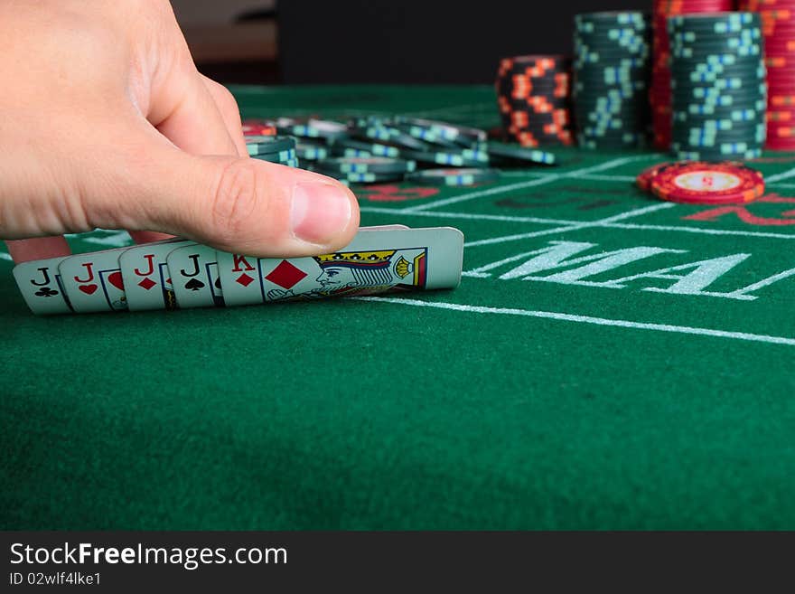 Casino card game showing chips on green cloth background. Casino card game showing chips on green cloth background