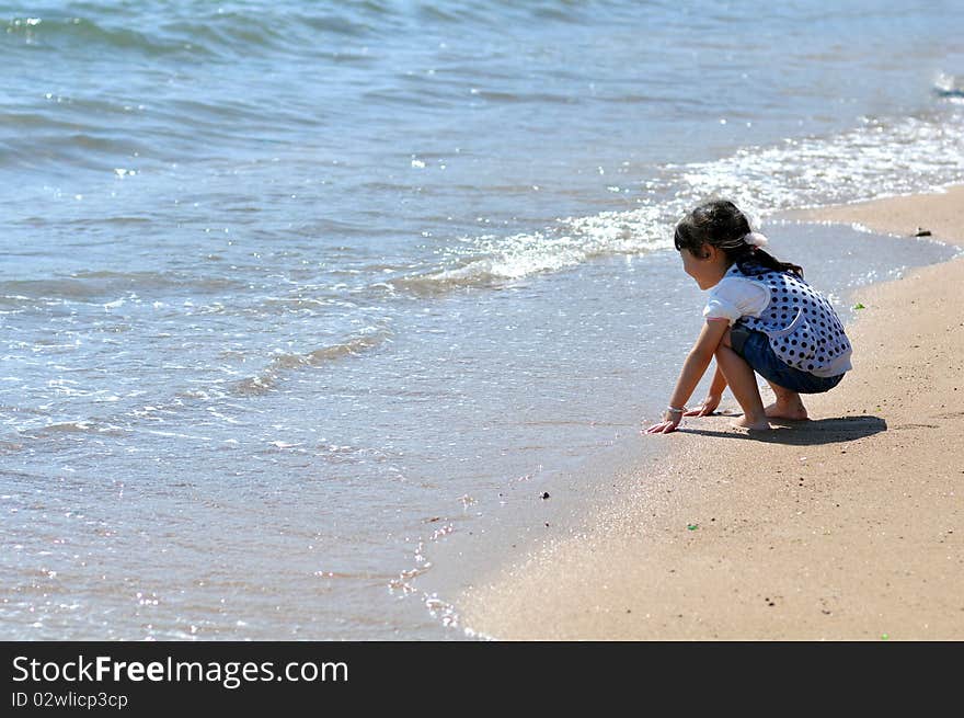 A Lovely Chinese girl，who is playing on the beach