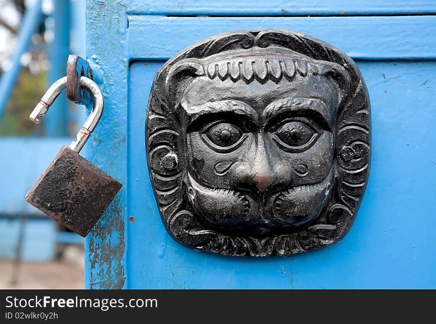 Original metal  door decoration and lock on the blue door