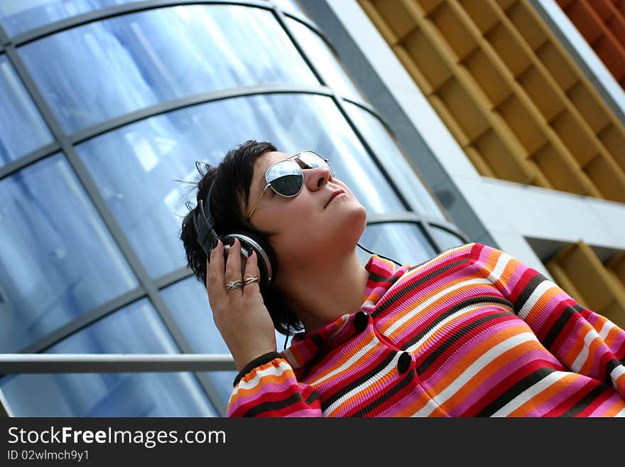 Attractive woman enjoying music outdoors