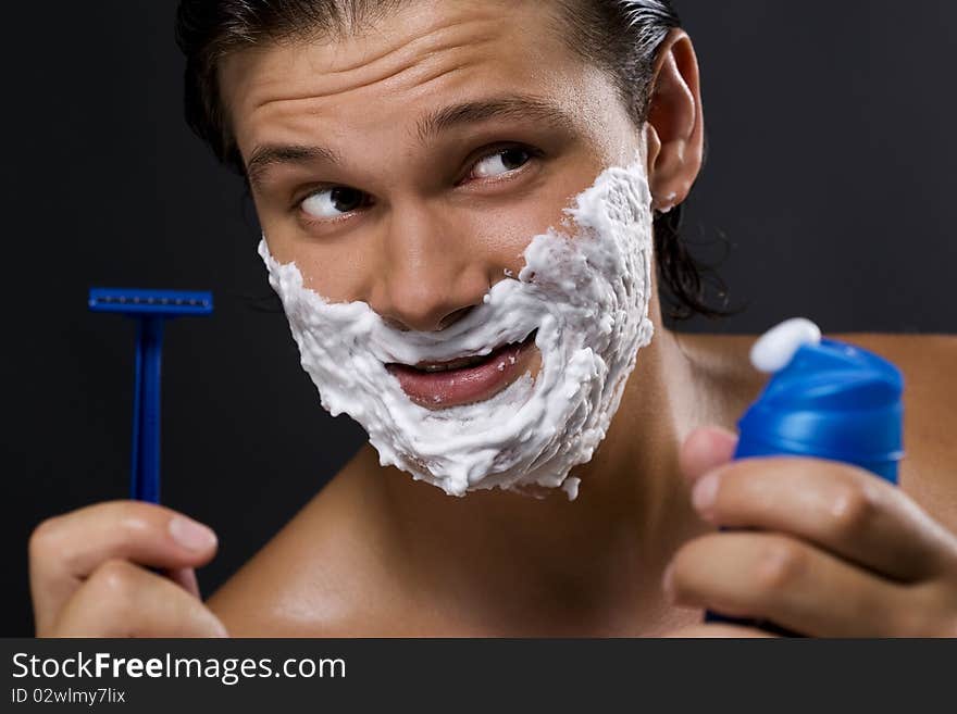 Handsome man shaving