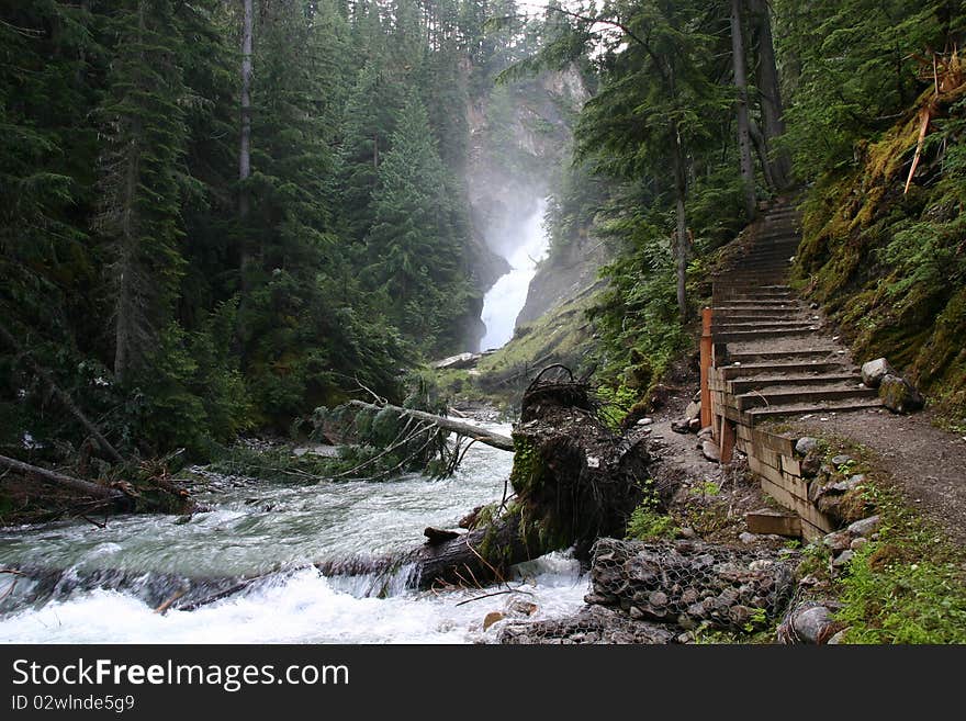 Waterfall in Glacier NP (British Columbia - Canada) with destroyed riverside in the result of snow and ice. Waterfall in Glacier NP (British Columbia - Canada) with destroyed riverside in the result of snow and ice