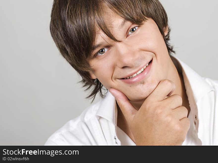 Closeup portrait of a charming young man smiling with copyspace. Closeup portrait of a charming young man smiling with copyspace