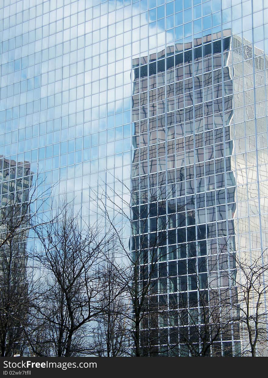 Skyscraper of glass in the reflection of glass house. Skyscraper of glass in the reflection of glass house