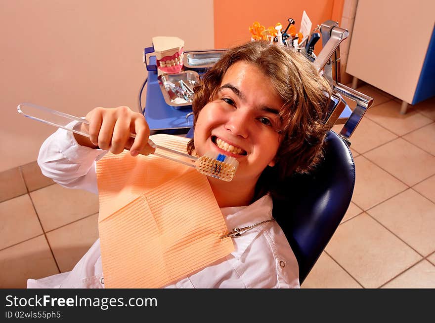 Photo of patient in consult room showing how to brush teeth. Photo of patient in consult room showing how to brush teeth.